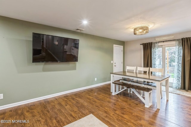 dining room with wood finished floors, baseboards, and recessed lighting