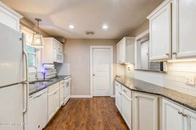 kitchen with white appliances, a sink, backsplash, dark wood-style floors, and white cabinetry