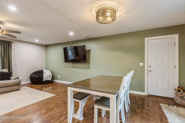 dining room featuring wood finished floors, baseboards, ceiling fan, recessed lighting, and a chandelier