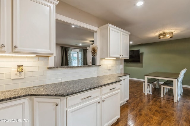 kitchen featuring dark wood-type flooring, baseboards, white cabinetry, backsplash, and recessed lighting