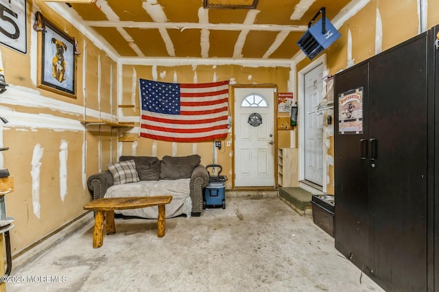 living room with unfinished concrete flooring