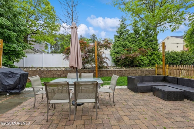 view of patio with a fenced backyard, grilling area, an outdoor living space, and outdoor dining area