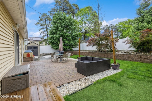 view of patio with a storage unit, outdoor lounge area, outdoor dining area, and an outdoor structure