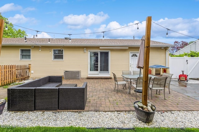 view of patio / terrace featuring an outdoor living space, a fenced backyard, a gate, and outdoor dining space