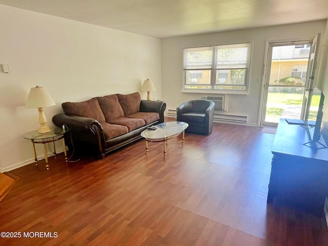 living area featuring wood finished floors, baseboard heating, a baseboard radiator, baseboards, and an AC wall unit