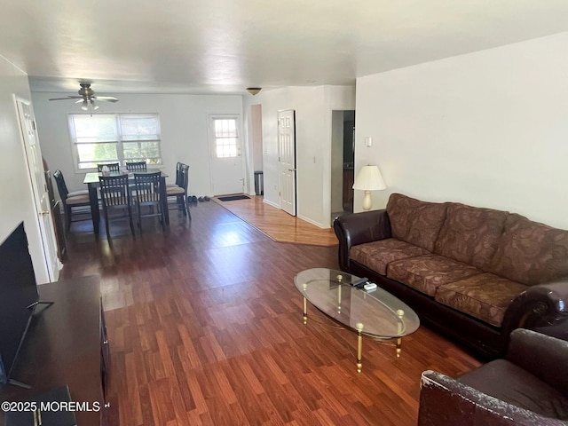 living room featuring a ceiling fan, wood finished floors, and baseboards