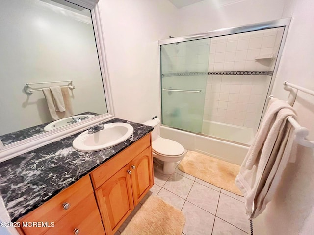 full bathroom with vanity, toilet, tile patterned flooring, and shower / bath combination with glass door