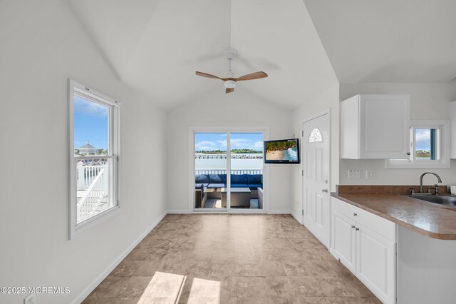 433 Bayside Ter Unit 1, Seaside Heights, NJ 08751 - kitchen with a sink, a ceiling fan, white cabinets, vaulted ceiling, and baseboards