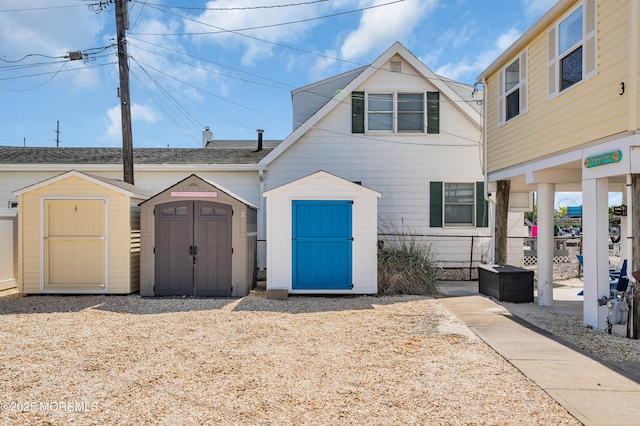 433 Bayside Ter Unit 1, Seaside Heights, NJ 08751 - view of front of property with a storage unit, an outdoor structure, and fence