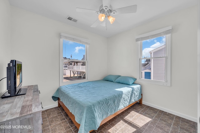 433 Bayside Ter Unit 1, Seaside Heights, NJ 08751 - bedroom with baseboards, stone finish flooring, and a ceiling fan