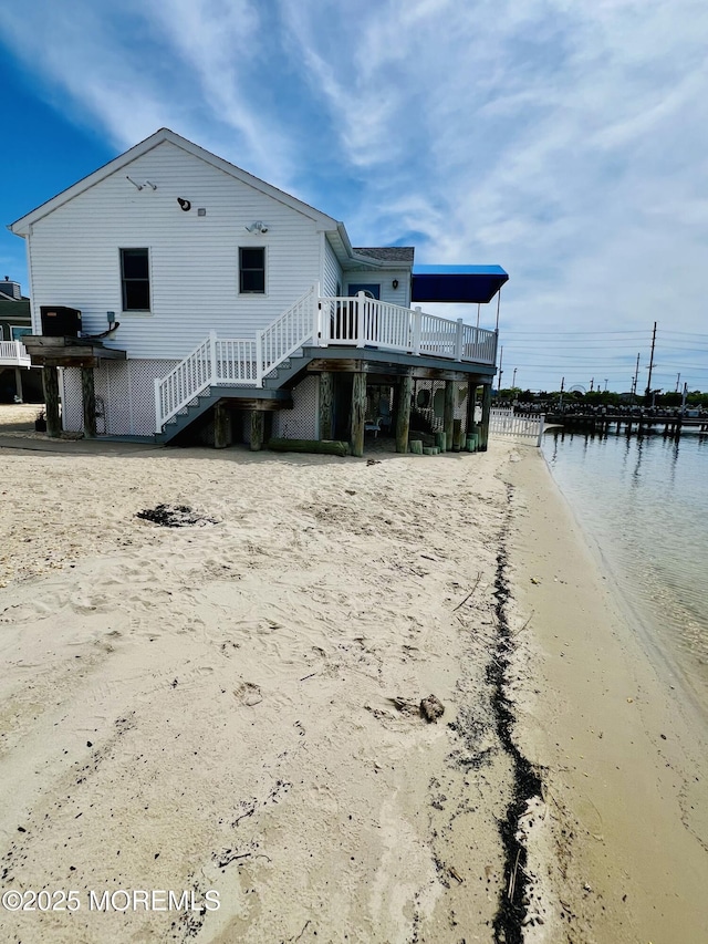 433 Bayside Ter Unit 1, Seaside Heights, NJ 08751 - back of property with stairway, a water view, and dirt driveway