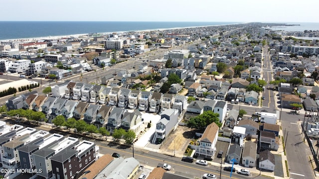 aerial view of property's location featuring a large body of water and nearby suburban area