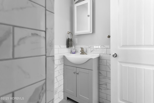 bathroom with tile walls, vanity, and wainscoting