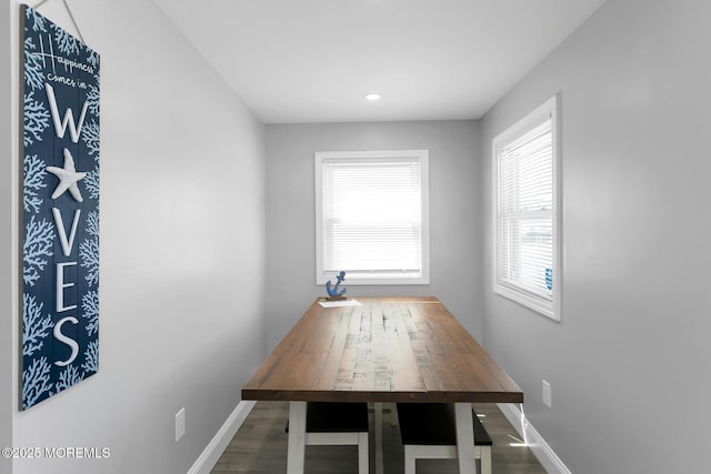 unfurnished dining area featuring baseboards, wood finished floors, and recessed lighting