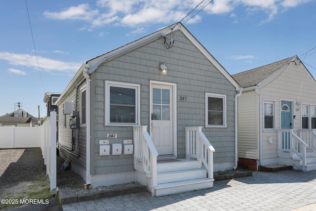 rear view of property with fence and a patio area