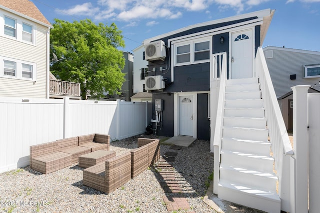 rear view of house featuring fence, an outdoor living space, and a cooling unit