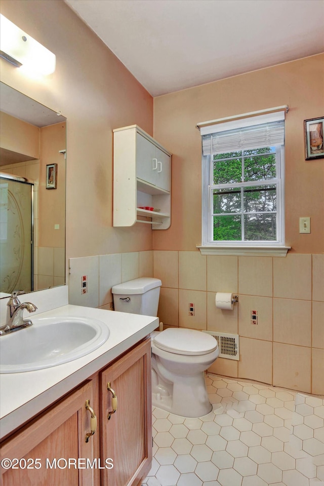 5 Isabella Dr, Lakewood, NJ 08701 - bathroom featuring tile patterned flooring, tile walls, a stall shower, toilet, and vanity