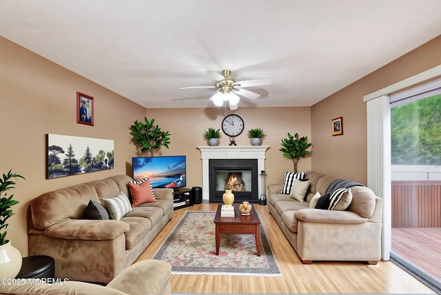 5 Isabella Dr, Lakewood, NJ 08701 - living room featuring light wood-style floors, ceiling fan, and a glass covered fireplace