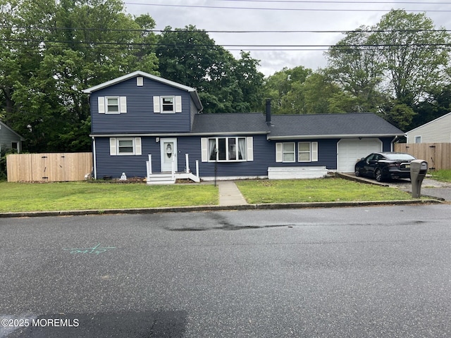 312 Dogwood Dr, Brick, NJ 08723 - view of front facade with a garage, asphalt driveway, and view of wooded area