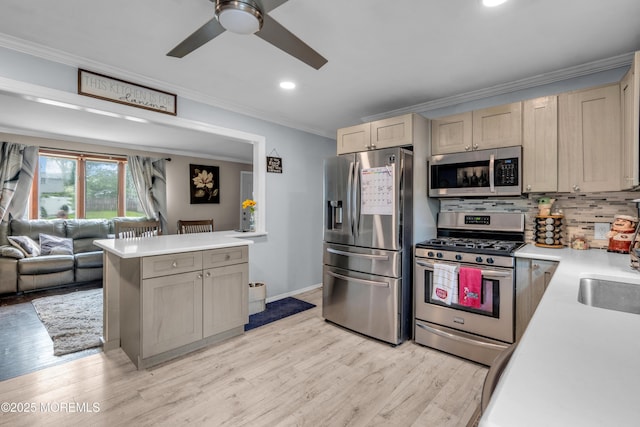 312 Dogwood Dr, Brick, NJ 08723 - kitchen featuring appliances with stainless steel finishes, crown molding, ceiling fan, open floor plan, and light countertops