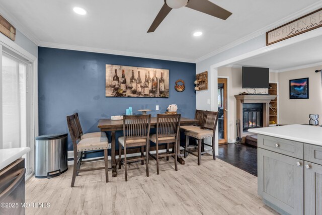 312 Dogwood Dr, Brick, NJ 08723 - dining room featuring ceiling fan, ornamental molding, a glass covered fireplace, recessed lighting, and light wood finished floors