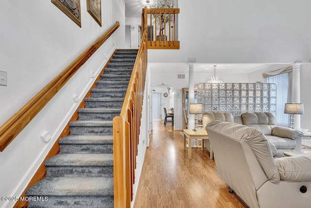 303 Diamond Rd, Jackson, NJ 08527 - stairs featuring wood finished floors, a chandelier, decorative columns, and a high ceiling