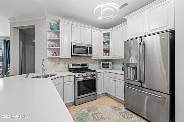 kitchen featuring stainless steel appliances, a sink, a chandelier, open shelves, and light countertops