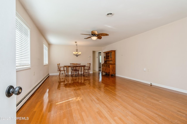 821 Jamaica Blvd, Toms River, NJ 08757 - dining area featuring a baseboard radiator, light wood finished floors, a chandelier, a ceiling fan, and baseboards