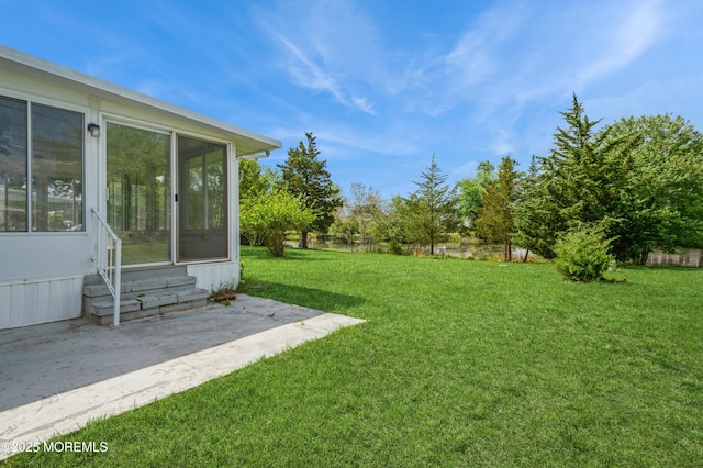 821 Jamaica Blvd, Toms River, NJ 08757 - view of grassy yard with entry steps, a patio, and a sunroom