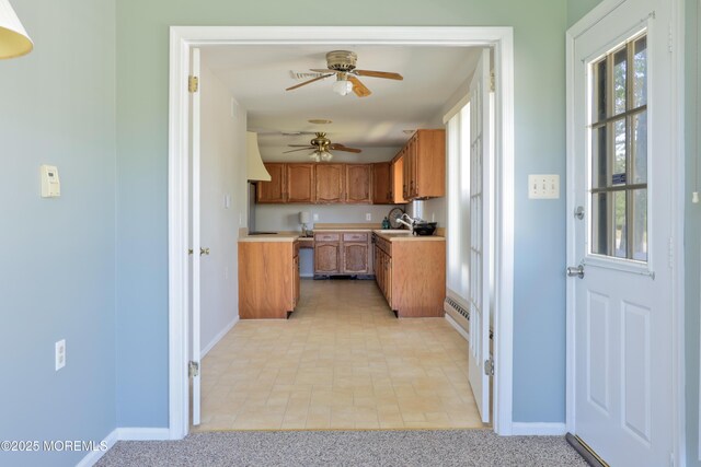 113 Ash Rd Unit 8, Manahawkin, NJ 08050 - kitchen featuring baseboards, a ceiling fan, a baseboard heating unit, light countertops, and brown cabinets
