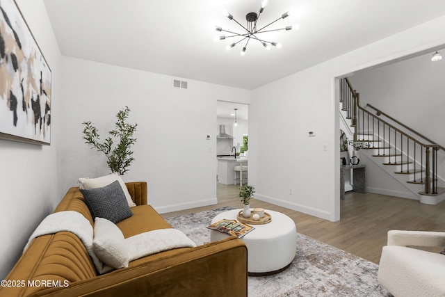 781 Harmony Rd, Jackson, NJ 08527 - living room with stairs, wood finished floors, a chandelier, and baseboards