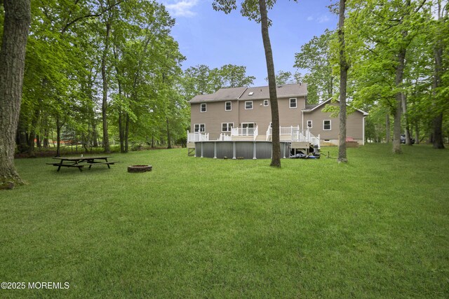 781 Harmony Rd, Jackson, NJ 08527 - view of grassy yard with an outdoor pool, an outdoor fire pit, and a wooden deck