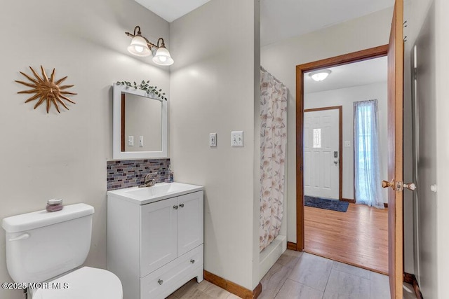 1430 Forest Ave, Brick, NJ 08724 - bathroom featuring toilet, decorative backsplash, vanity, a shower with shower curtain, and baseboards
