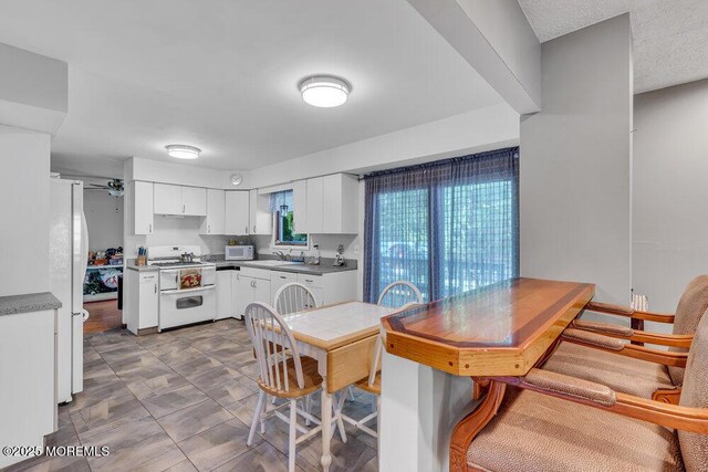 1430 Forest Ave, Brick, NJ 08724 - kitchen featuring white appliances, a sink, white cabinetry, and ceiling fan