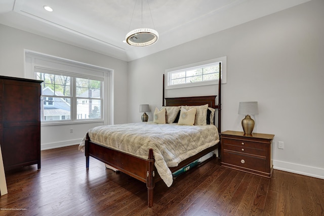 bedroom featuring baseboards, wood finished floors, recessed lighting, and a chandelier