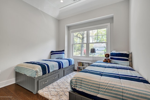 bedroom with baseboards and wood finished floors