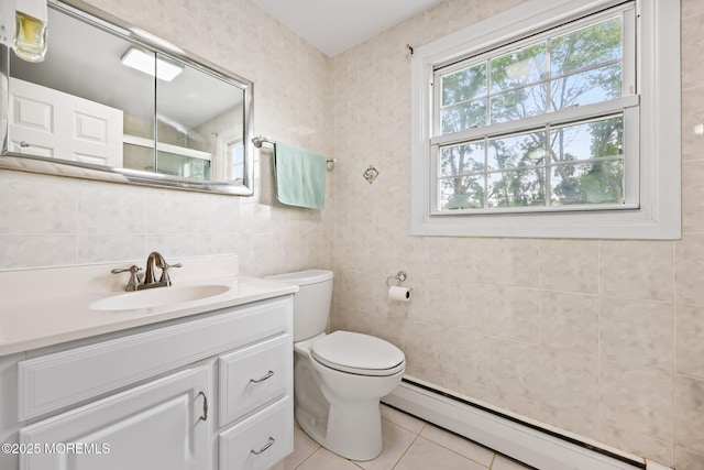 bathroom with a baseboard radiator, tile patterned flooring, tile walls, toilet, and vanity