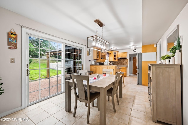 dining area featuring light tile patterned flooring and baseboards