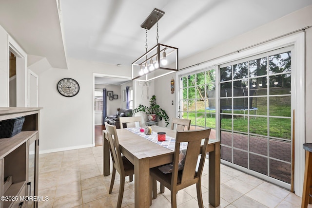 dining room with baseboards and light tile patterned floors