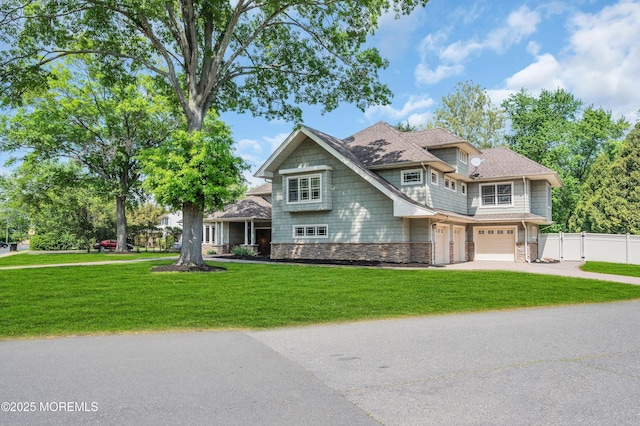 view of front of home with stone siding, driveway, and an attached garage