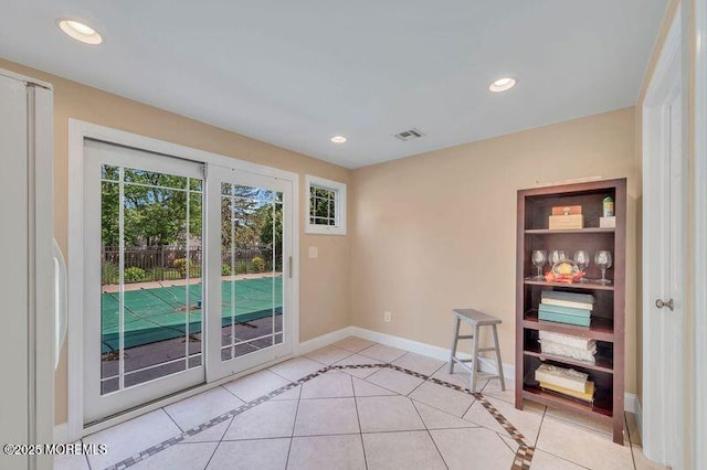 entryway featuring light tile patterned floors, baseboards, and recessed lighting