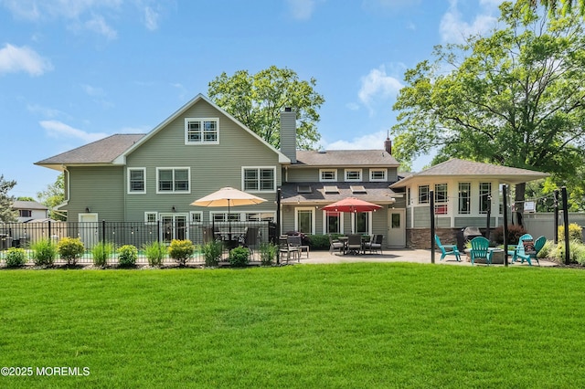 rear view of property featuring a patio area, a chimney, and a fire pit