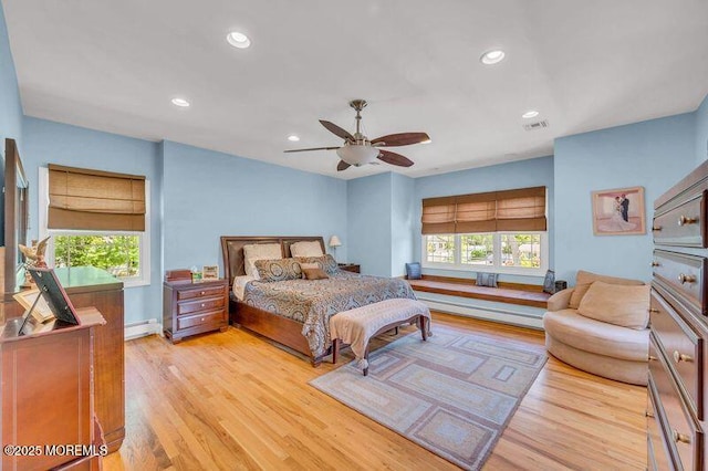 bedroom featuring a baseboard heating unit, light wood-style floors, recessed lighting, and ceiling fan