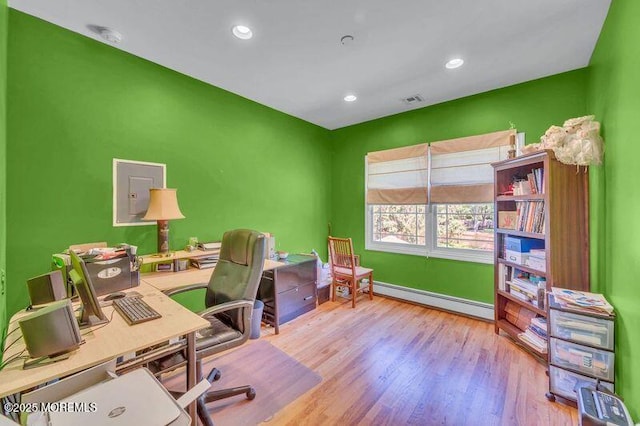 office featuring baseboard heating, wood finished floors, baseboards, and recessed lighting