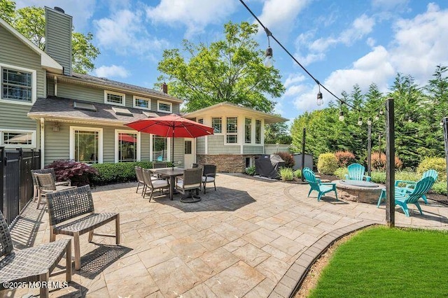 view of patio / terrace with fence and a fire pit
