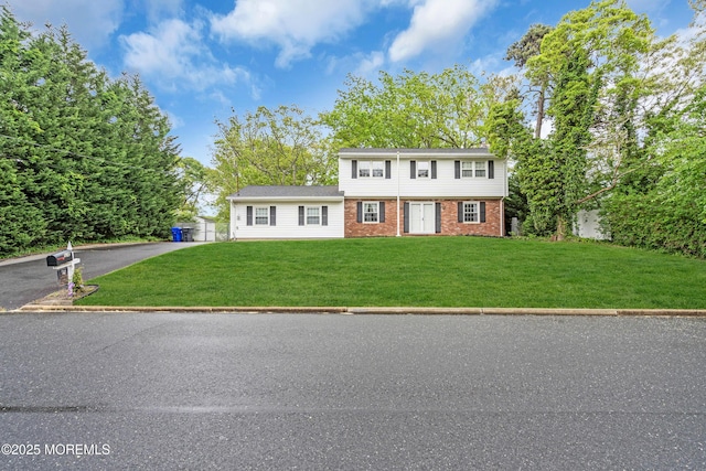132 Tunes Brook Dr, Brick, NJ 08723 - colonial-style house featuring a front yard and brick siding