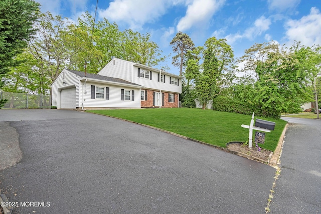 132 Tunes Brook Dr, Brick, NJ 08723 - colonial home with brick siding, a garage, and asphalt driveway