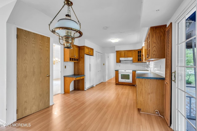132 Tunes Brook Dr, Brick, NJ 08723 - kitchen featuring white appliances, brown cabinetry, light wood-type flooring, tasteful backsplash, and glass insert cabinets