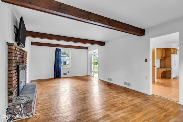 132 Tunes Brook Dr, Brick, NJ 08723 - unfurnished living room featuring light wood-style floors, a brick fireplace, beam ceiling, and baseboards