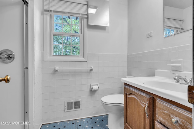 132 Tunes Brook Dr, Brick, NJ 08723 - bathroom featuring tile walls, tile patterned floors, vanity, toilet, and a wainscoted wall